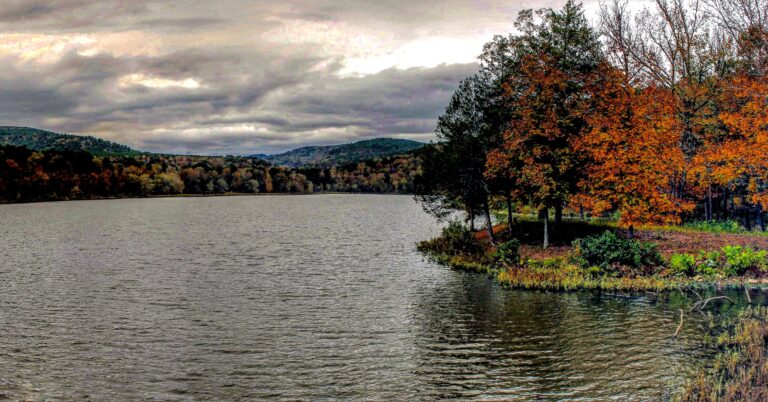 Overlook of Shores Lake on a late fall evening with a mix of autumn colors reflecting in the calm waters.
